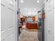 Open-concept kitchen with stainless steel appliances and bar stool seating, seen through the front door at 11466 Captiva Kay Dr, Riverview, FL 33569