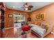 Cozy living room offers comfortable seating, hardwood floors, and access to screened patio at 11466 Captiva Kay Dr, Riverview, FL 33569