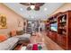 Wide angle shot of the living room with dining area, hardwood flooring, fan and view to the front door at 11466 Captiva Kay Dr, Riverview, FL 33569