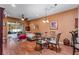 Open-concept living room with hardwood floors, a glass table, and a view to the screened-in patio at 11466 Captiva Kay Dr, Riverview, FL 33569