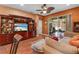 Cozy living room boasts custom built-ins, wood flooring, and access to a screened-in patio with seating at 11466 Captiva Kay Dr, Riverview, FL 33569