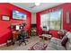 Bright office space features red accent walls, wood floors, and a large window with natural light at 11466 Captiva Kay Dr, Riverview, FL 33569