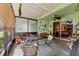 Relaxing screened patio featuring a ceiling fan and comfortable seating for outdoor enjoyment at 11466 Captiva Kay Dr, Riverview, FL 33569