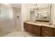 Bright bathroom featuring wood cabinets, stone countertops, and a walk-in shower at 11506 Harbourside Ln, Parrish, FL 34219