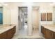 Bright bathroom featuring dual vanities with stone countertops and separate toilet room at 11506 Harbourside Ln, Parrish, FL 34219