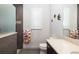 Bathroom featuring a window, walk-in shower, toilet, and large vanity at 11506 Harbourside Ln, Parrish, FL 34219
