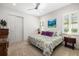 Bright bedroom with a ceiling fan, closet and a scenic nautical painting at 11506 Harbourside Ln, Parrish, FL 34219