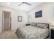 Bedroom featuring neutral decor, a ceiling fan, and a door to an ensuite bathroom at 11506 Harbourside Ln, Parrish, FL 34219