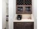 Stylish coffee bar with a built-in wine rack, mosaic backsplash, and modern coffee machine at 11506 Harbourside Ln, Parrish, FL 34219