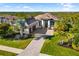 Beautifully landscaped home with a brick driveway and lush green lawn at 11506 Harbourside Ln, Parrish, FL 34219