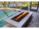 Stunning view of the in-ground pool with an inviting gas fire pit, perfect for entertaining and creating a cozy atmosphere at 11506 Harbourside Ln, Parrish, FL 34219