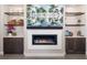 Modern fireplace with a white surround, built-in shelving, and a TV above at 11506 Harbourside Ln, Parrish, FL 34219