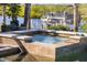 Inviting in-ground hot tub with decorative tile surround, creating a relaxing spa-like experience by the water at 11506 Harbourside Ln, Parrish, FL 34219
