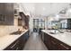 Modern kitchen featuring dark wood cabinets, quartz countertops and stainless steel appliances at 11506 Harbourside Ln, Parrish, FL 34219