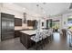 Modern kitchen with stainless steel appliances and a center island with seating at 11506 Harbourside Ln, Parrish, FL 34219
