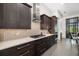 Modern kitchen features dark cabinets, quartz countertops and stainless steel appliances at 11506 Harbourside Ln, Parrish, FL 34219