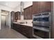 Modern kitchen features stainless steel appliances, dark cabinets and gas range at 11506 Harbourside Ln, Parrish, FL 34219