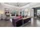 Spacious living room with modern furnishings, a fireplace, and decorative shelving at 11506 Harbourside Ln, Parrish, FL 34219