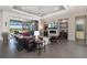 Open-concept living room with a fireplace, a TV, and outdoor patio access with water views at 11506 Harbourside Ln, Parrish, FL 34219