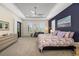 Spacious main bedroom featuring a tray ceiling, ceiling fan, and access to a patio at 11506 Harbourside Ln, Parrish, FL 34219