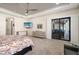 Well-lit main bedroom featuring patio access and a ceiling fan at 11506 Harbourside Ln, Parrish, FL 34219