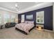 Stylish main bedroom featuring a ceiling fan, a dark accent wall, and bright natural light at 11506 Harbourside Ln, Parrish, FL 34219