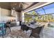 Well-equipped outdoor kitchen and dining area, perfect for entertaining with views of the pool and waterfront at 11506 Harbourside Ln, Parrish, FL 34219