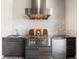 Outdoor kitchen featuring stainless steel appliances, dark cabinets, and a stylish backsplash, ideal for outdoor cooking at 11506 Harbourside Ln, Parrish, FL 34219