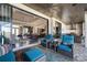 Spacious outdoor living area with comfortable seating, an outdoor kitchen, and views of the interior living spaces at 11506 Harbourside Ln, Parrish, FL 34219
