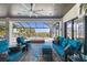 Covered patio with outdoor seating, fire pit, and stunning water views, creating an ideal space for relaxation and entertainment at 11506 Harbourside Ln, Parrish, FL 34219