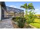 Enjoy the outdoors with a screened-in pool, lush landscaping, and serene waterfront views from your backyard oasis at 11506 Harbourside Ln, Parrish, FL 34219
