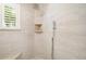 Elegant walk-in shower featuring decorative stone, built-in shelf, and dual shower heads at 11506 Harbourside Ln, Parrish, FL 34219
