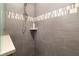 Modern shower with gray tiling, a small corner shelf, and accent tile at 11506 Harbourside Ln, Parrish, FL 34219
