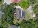 Drone shot of the home showing a pool with screen enclosure, roof and greenery around the house at 13004 Bell Creek Chase, Riverview, FL 33569