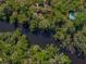 Aerial view of house and wooded area along a small river at 13004 Bell Creek Chase, Riverview, FL 33569