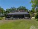 Expansive backyard featuring an in-ground pool and screen enclosure with mature trees and greenery at 13004 Bell Creek Chase, Riverview, FL 33569