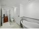 Bathroom features a standalone bathtub, toilet, and a doorway at 13004 Bell Creek Chase, Riverview, FL 33569