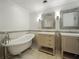 Bathroom features double sink vanity, standalone bathtub, and tiled walls at 13004 Bell Creek Chase, Riverview, FL 33569