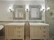 Bathroom features double sink vanity with decorative mirrors, tiled walls, and glass enclosed shower at 13004 Bell Creek Chase, Riverview, FL 33569