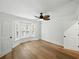 Light filled bedroom featuring a bay window with shutters, hardwood floors, and ceiling fan at 13004 Bell Creek Chase, Riverview, FL 33569