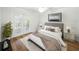 Comfortable bedroom with French doors to the balcony, hardwood floors, and modern decor at 13004 Bell Creek Chase, Riverview, FL 33569