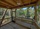 Outdoor deck overlooking a serene river setting, built-in seating, wooden railing and scenic views at 13004 Bell Creek Chase, Riverview, FL 33569