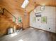 Open-concept interior featuring wood walls, high ceilings with skylights, and a unique staircase leading to the loft at 13004 Bell Creek Chase, Riverview, FL 33569