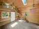 Open-concept interior featuring wood walls, high ceilings with skylights, and a unique staircase leading to the loft at 13004 Bell Creek Chase, Riverview, FL 33569