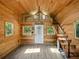 Open-concept interior featuring wood walls, high ceilings with skylights, and a unique staircase leading to the loft at 13004 Bell Creek Chase, Riverview, FL 33569
