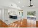 Modern kitchen with a large island, white cabinets, and stainless steel appliances, connecting to the outdoor pool area at 13004 Bell Creek Chase, Riverview, FL 33569