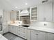 Well-lit kitchen features marble countertops, modern appliances, decorative backsplash, and glass-front cabinets at 13004 Bell Creek Chase, Riverview, FL 33569