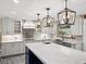 Stunning kitchen featuring updated appliances, light fixtures, and a spacious island, offering backyard views at 13004 Bell Creek Chase, Riverview, FL 33569
