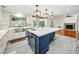 Stylish kitchen boasts an island with seating, stainless steel appliances, a view of the back yard and an open floorplan at 13004 Bell Creek Chase, Riverview, FL 33569