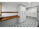 Laundry room featuring patterned floors, butcher block counters, built-in shelves, and ample cabinet space at 13004 Bell Creek Chase, Riverview, FL 33569